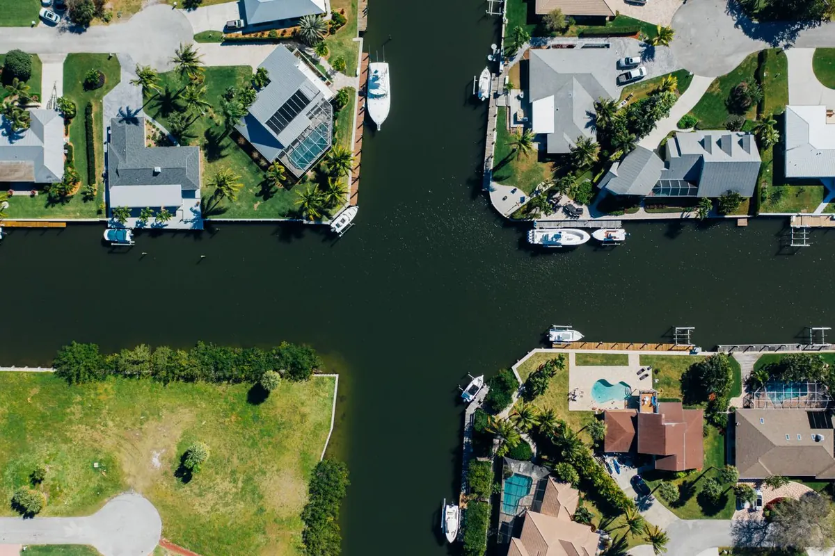 Aerial view of canal-front homes with private docks and boats along the waterways
